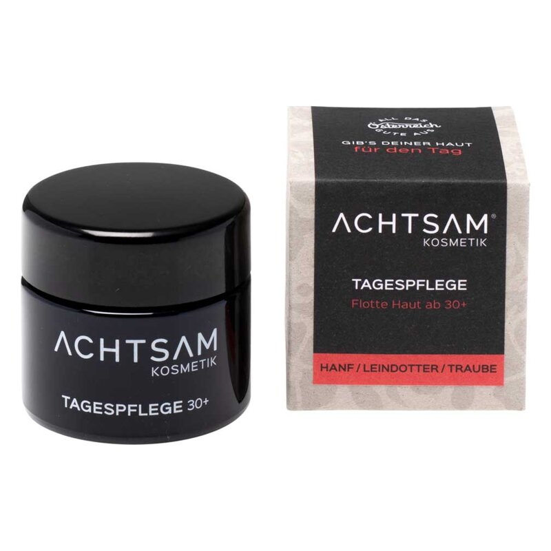 Schwarzer Tiegel mit Tagespflege für Haut ab 30+, daneben Verpackung in Naturpapier mit Hanf, Leindotter und Traube.
