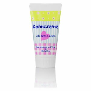 Zahncreme in einer Tube mit buntem Design, geeignet für die Pflege von Milchzähnen.