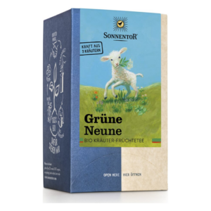Verpackung von Sonnentor Grüner Neune Bio Kräuter-Früchtetee mit einem Schaf auf der Vorderseite und buntem, natürlichen Hintergrund.