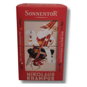 Geschenkpackung mit Bio-Tees, dekoriert mit Nikolaus und Krampus Illustrationen auf rotem Hintergrund.