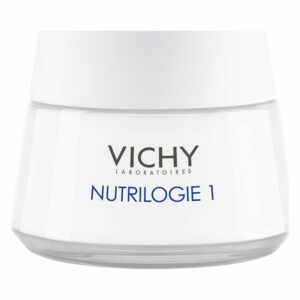 Eine weiße Creme in einem Glasbehälter mit einem grauen Deckel, gekennzeichnet mit "VICHY NUTRILOGIE 1".