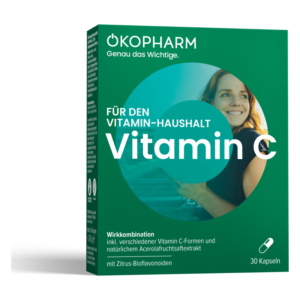 Verpackung mit der Aufschrift "Vitamin C" und einer Frau, die lächelt, auf grünem Hintergrund.
