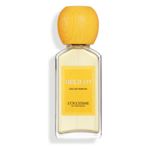 Flasche mit Eau de Parfum, transparent, eckig, gelbes Etikett mit der Aufschrift MELILOT und holzfarbener Kappe.