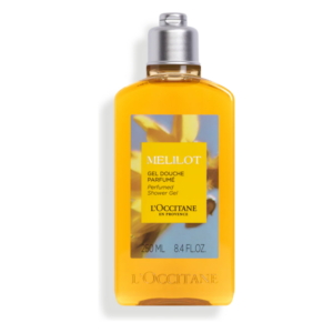 Gel-Dusche in einer transparenten Flasche mit gelbem Inhalt und floralem Label von L'Occitane.