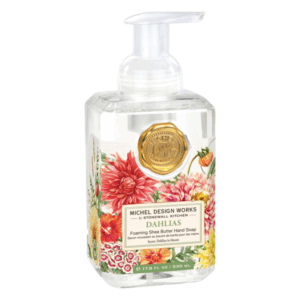 Flüssigseife in einer transparenten Pumpflasche mit buntem Blumenmuster und goldenem Siegel.