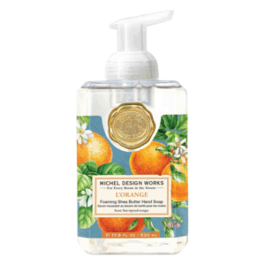 Eine Flasche handschäumender Seife mit orangefarbenem Design und Blumenmuster, Duft nach sonnenreifen Orangen.