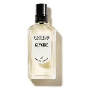 Glasflasche mit transparentem Duft, schwarzen Verschluss und Etikett mit der Aufschrift 'Glycine' von L'Occitane.