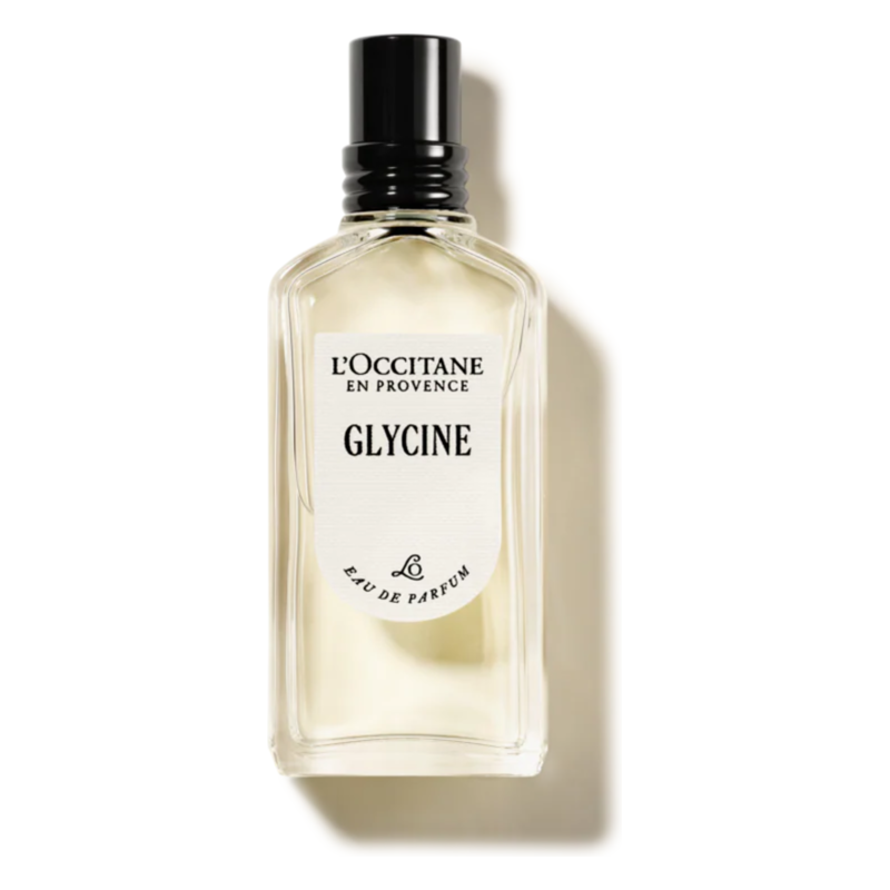 Glasflasche mit transparentem Duft, schwarzen Verschluss und Etikett mit der Aufschrift 'Glycine' von L'Occitane.