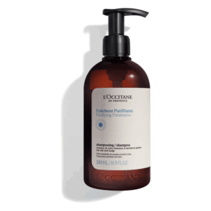Braune Flasche mit Pumpspender, beschriftet mit 'L'Occitane Purifying Freshness Shampoo' für fettiges Haar und Kopfhaut.