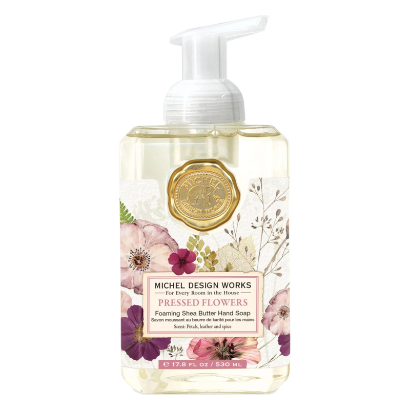 Flüssige Schaumbutterschampoo-Seife in einer transparenten Pumpflasche mit floralem Design.