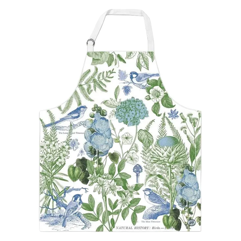 Schürze mit botanischem Muster aus grünen Pflanzen und blauen Vögeln auf weißem Hintergrund.
