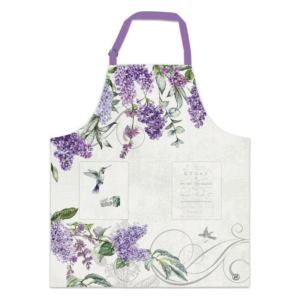 Kochschürze mit lila Fliederblüten und einem Kolibri-Motiv auf hellem Hintergrund.